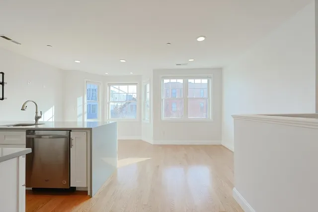 a view of a kitchen with a sink and a window