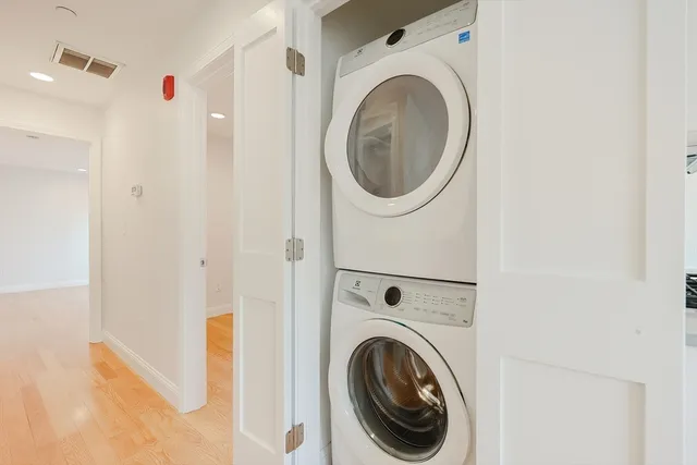 a view of a hallway with washer and dryer