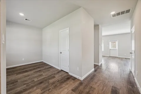a view of a room with wooden floor
