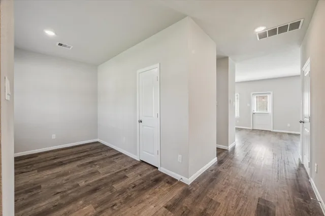 a view of a room with wooden floor