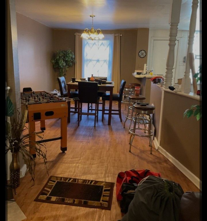 6706 South Parnell Avenue Chicago, IL 60621 - Photo 19 of 21 a living room with a rug and a dining table