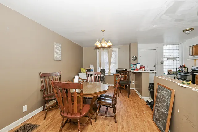 a view of a dining room with furniture and chandelier