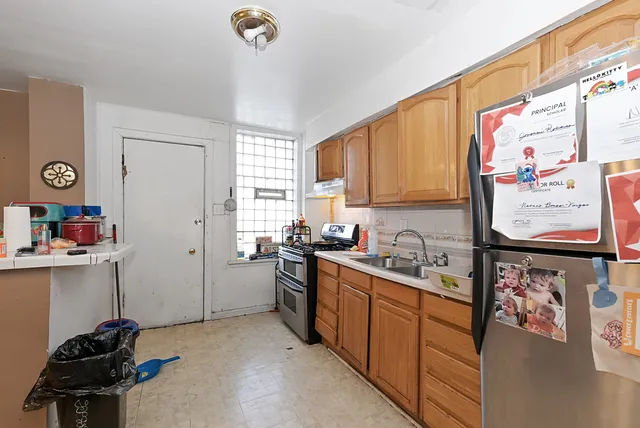 a kitchen with a sink appliances and cabinets