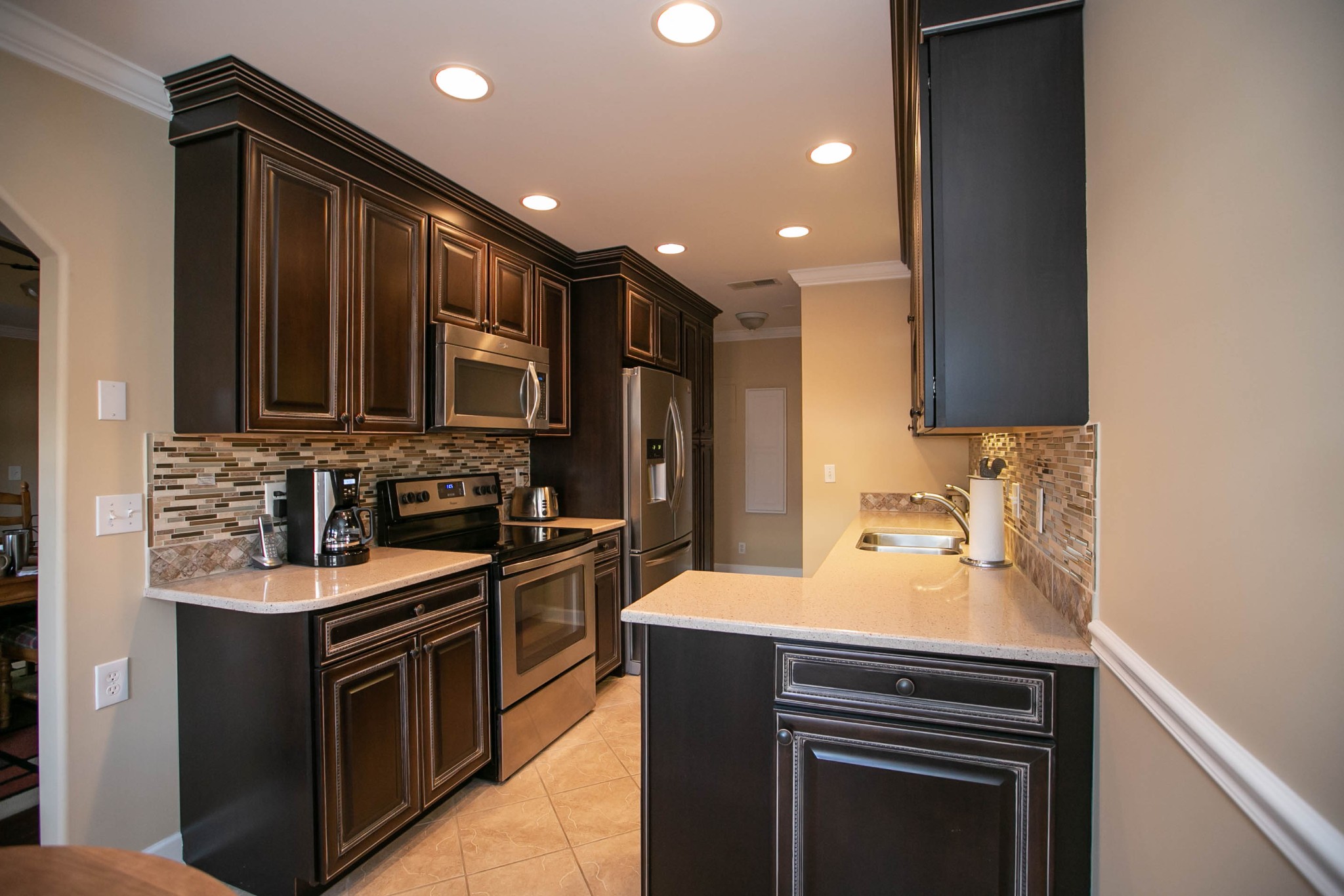 1321 General George Patton Road Nashville, TN 37221 - Photo 9 of 29 a kitchen with a sink stainless steel appliances wooden cabinets and a counter top space