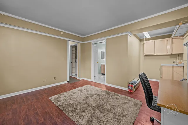 a view of workspace with wooden floor and bedroom