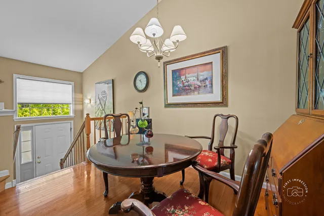 a view of a dining room with furniture and a chandelier