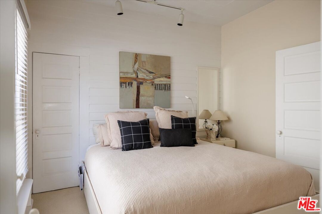 2315 Cove Avenue Los Angeles, CA 90039 - Photo 17 of 49 a bedroom with a bed and a mirror