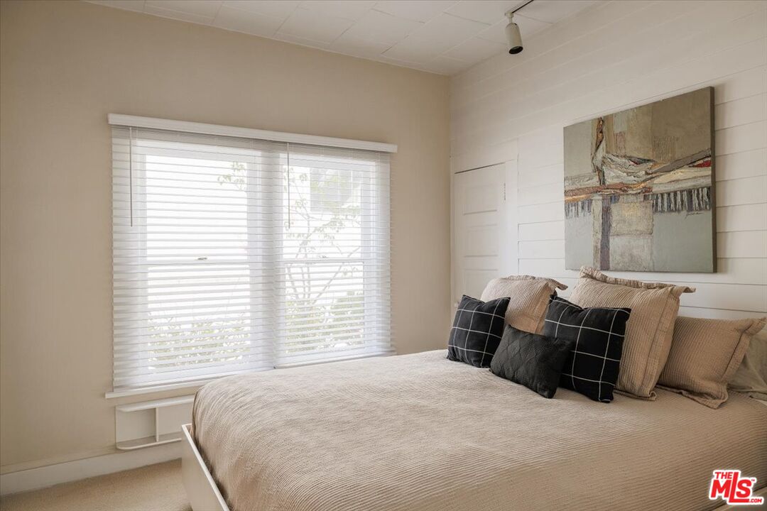 2315 Cove Avenue Los Angeles, CA 90039 - Photo 18 of 49 a bedroom with a bed and glass window