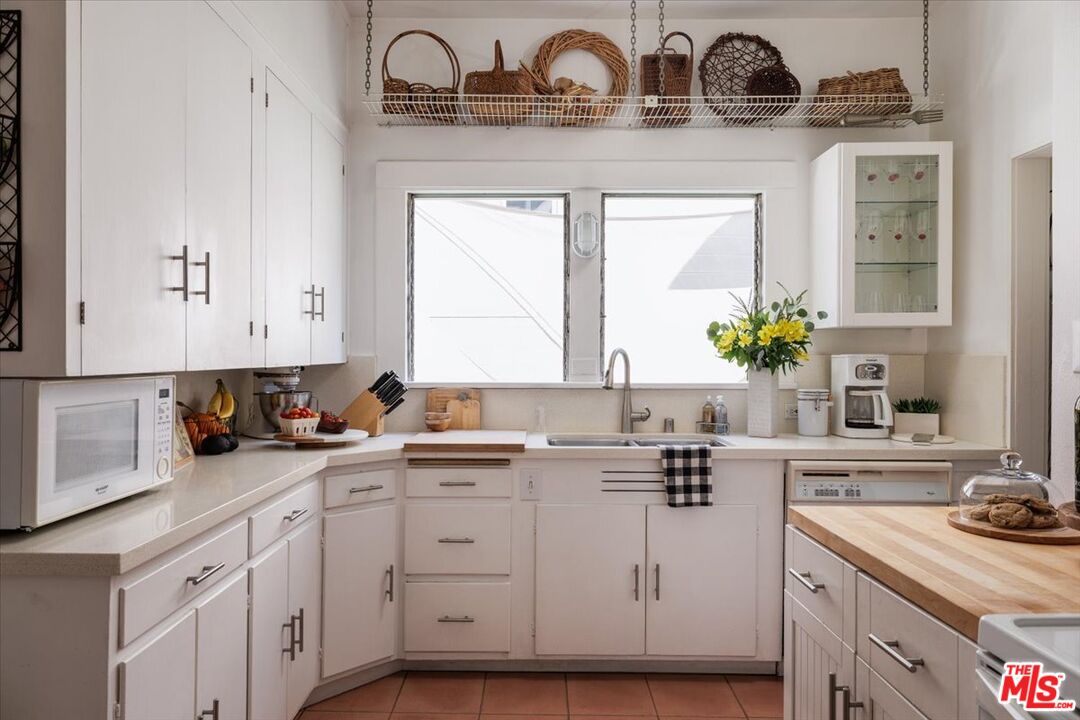 2315 Cove Avenue Los Angeles, CA 90039 - Photo 20 of 49 a kitchen with cabinets appliances a sink and a window