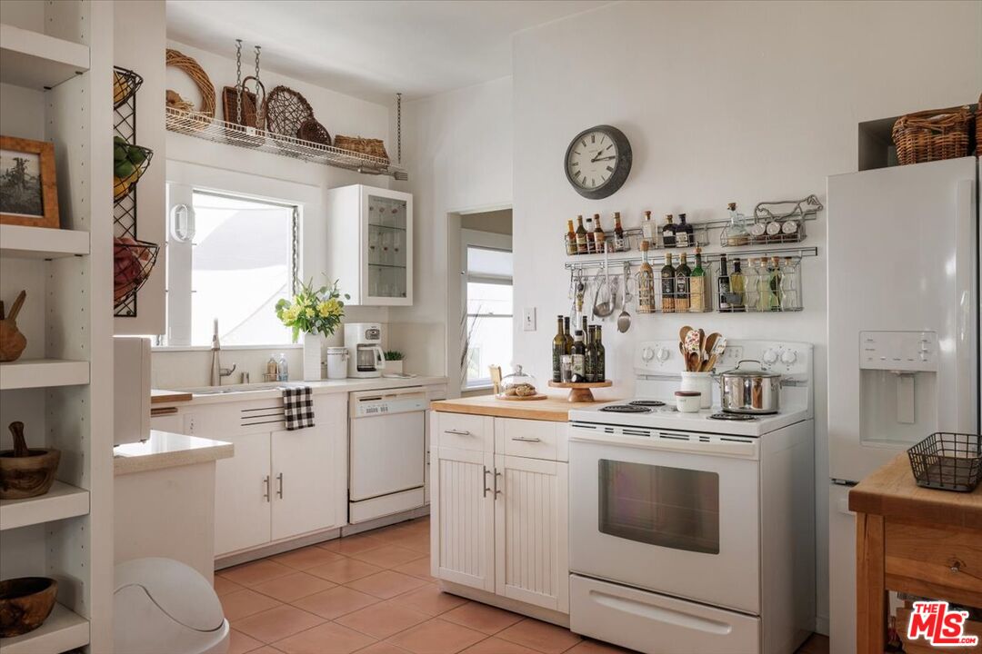 2315 Cove Avenue Los Angeles, CA 90039 - Photo 21 of 49 a kitchen with a stove top oven sink and cabinets