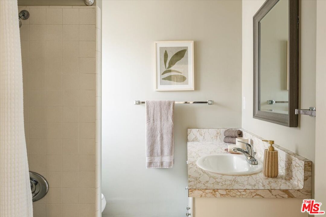 2315 Cove Avenue Los Angeles, CA 90039 - Photo 48 of 49 a bathroom with a sink and a mirror