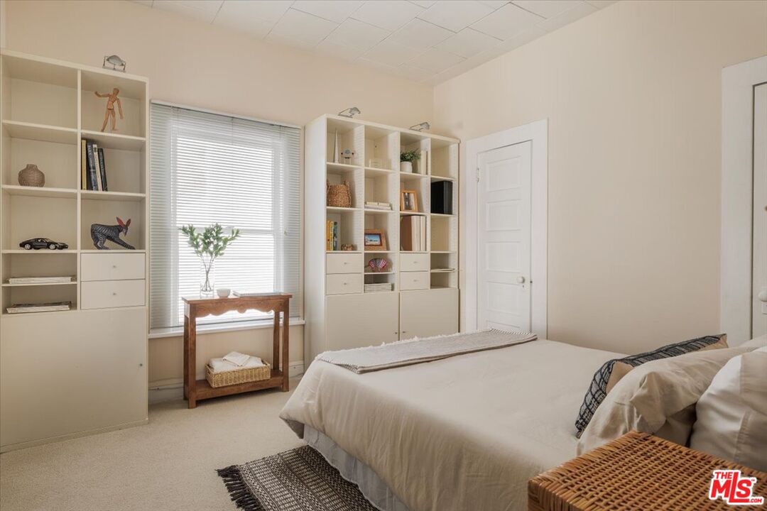 2315 Cove Avenue Los Angeles, CA 90039 - Photo 10 of 49 a bedroom with a bed and wooden floor