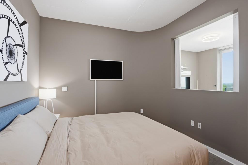 361 17th Street Northwest, Unit 1720 Atlanta, GA 30363 - Photo 11 of 38 a bedroom with a bed and a tv