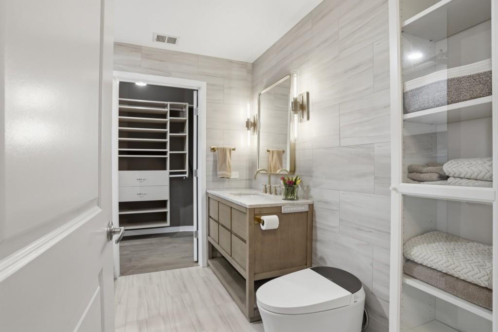 361 17th Street Northwest, Unit 1720 Atlanta, GA 30363 - Photo 18 of 38 a bathroom with a granite countertop toilet sink and mirror