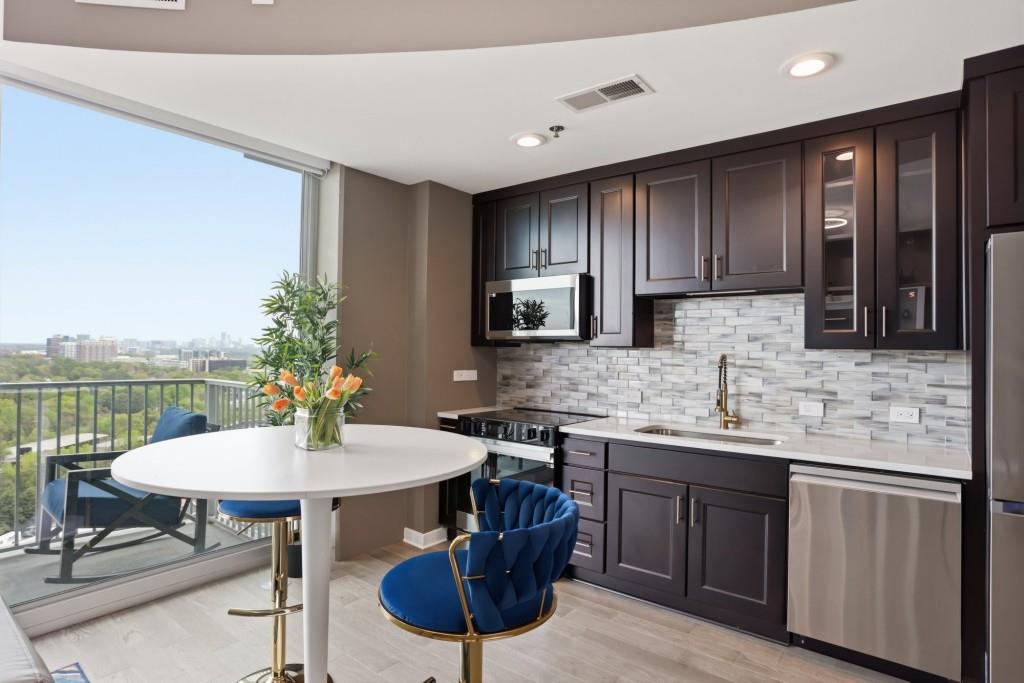 361 17th Street Northwest, Unit 1720 Atlanta, GA 30363 - Photo 2 of 38 a kitchen with a table chairs sink and cabinets