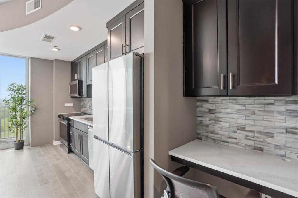 361 17th Street Northwest, Unit 1720 Atlanta, GA 30363 - Photo 9 of 38 a kitchen with a sink stainless steel appliances and cabinets