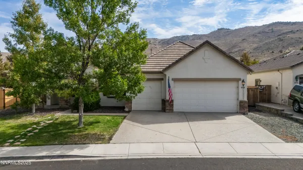 a view of a house with a yard and garage