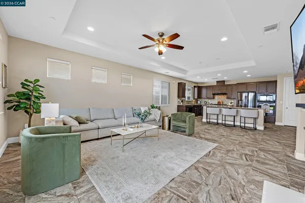 a living room with furniture and kitchen view