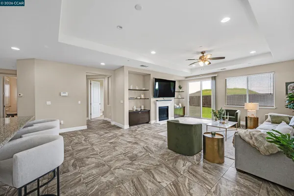 a living room with furniture a fireplace and a flat screen tv