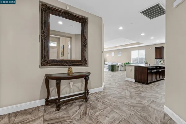 a living room with stainless steel appliances kitchen island granite countertop furniture and a view of kitchen