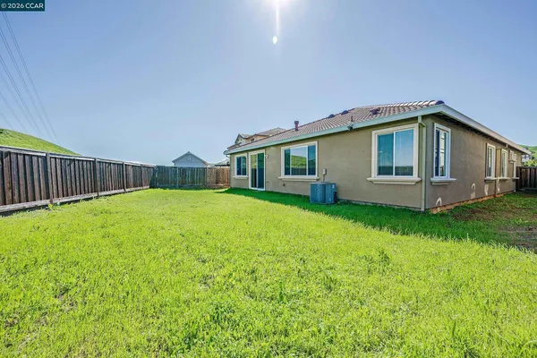 a yellow house with garden in front of it