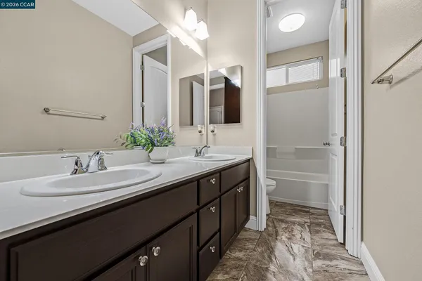 a bathroom with a double vanity sink and a mirror