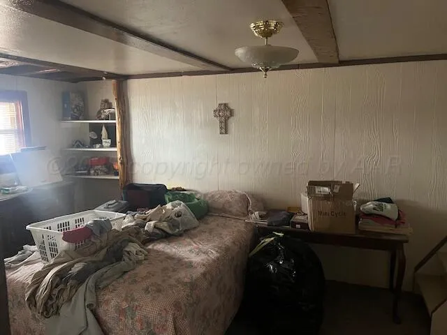a bed sitting in a bedroom next to a window