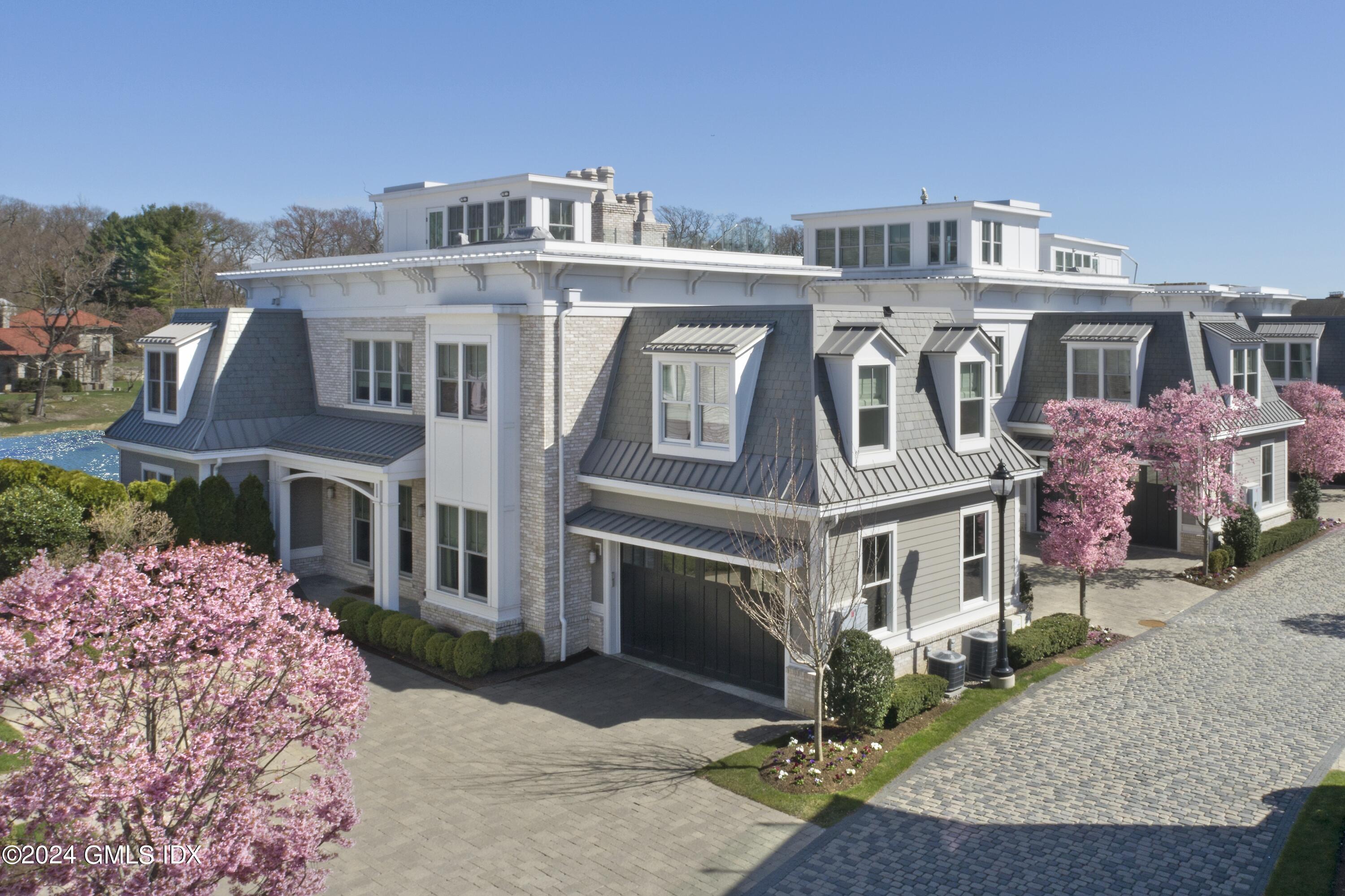 2 Oneida Drive, Unit F Greenwich, CT 06830 - Photo 1 of 31 a front view of a multi story residential apartment building