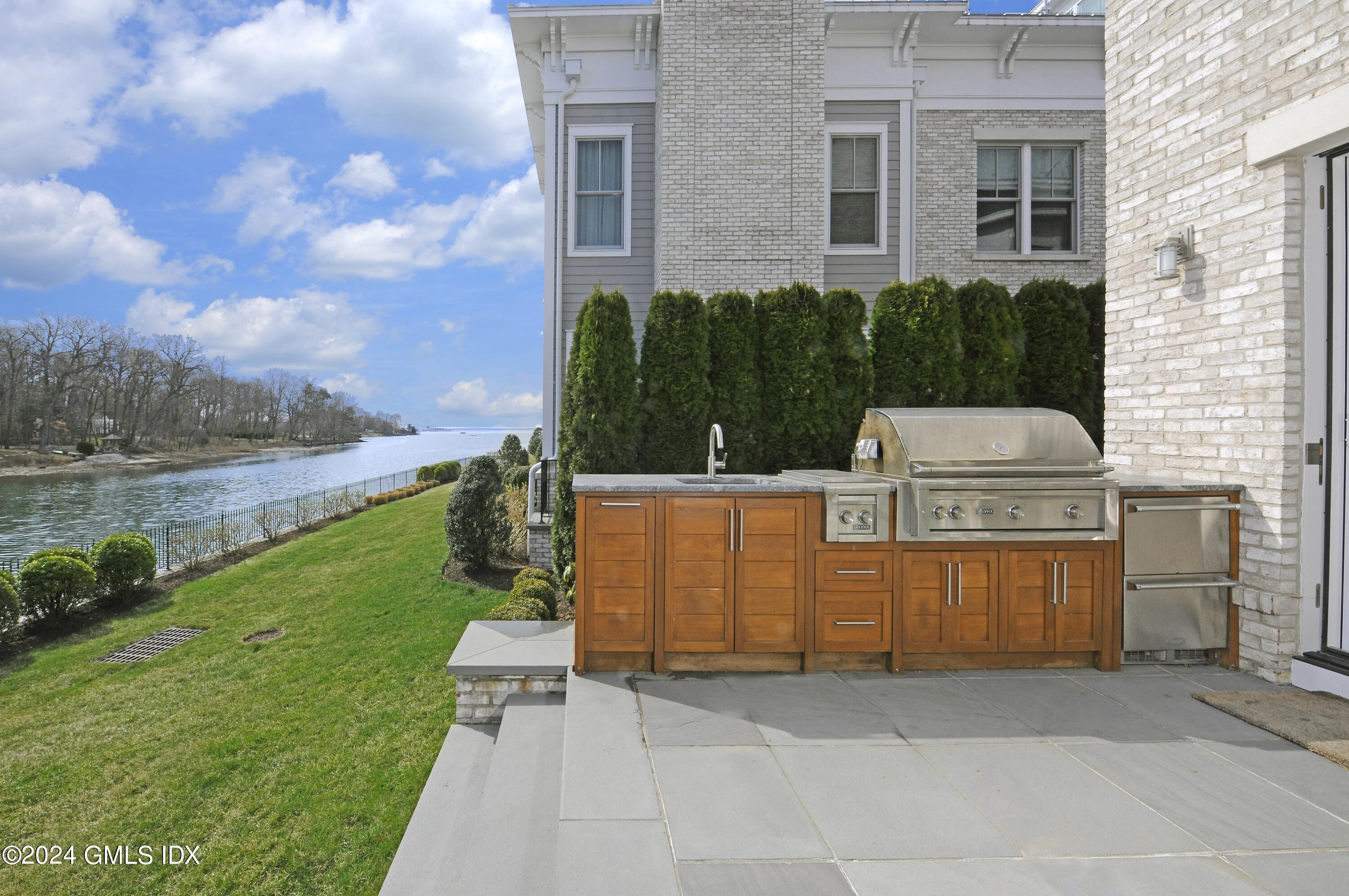 2 Oneida Drive, Unit F Greenwich, CT 06830 - Photo 11 of 31 a view of a garden with lawn chairs