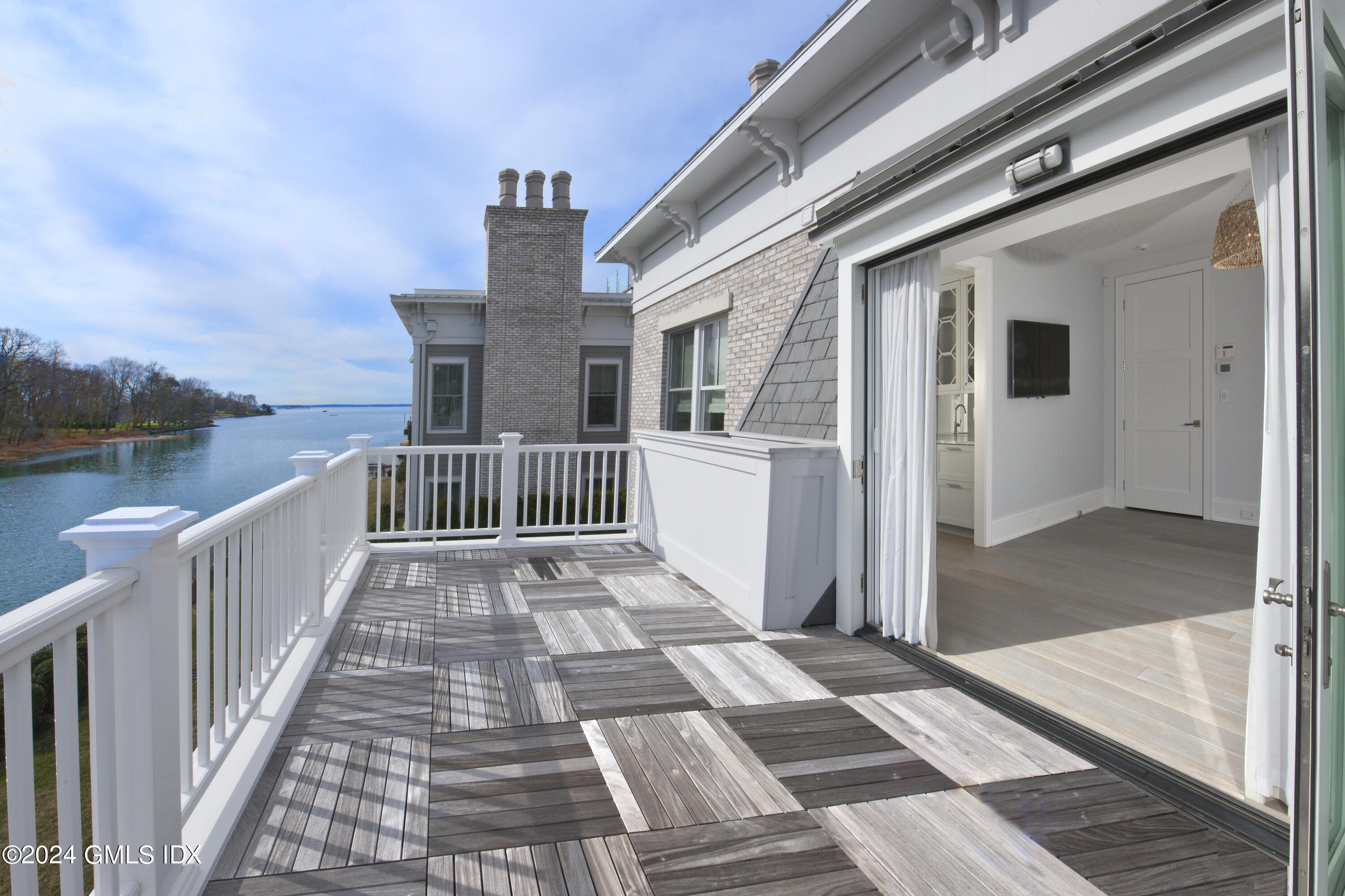 2 Oneida Drive, Unit F Greenwich, CT 06830 - Photo 15 of 31 a view of a house with wooden floor next to a lake