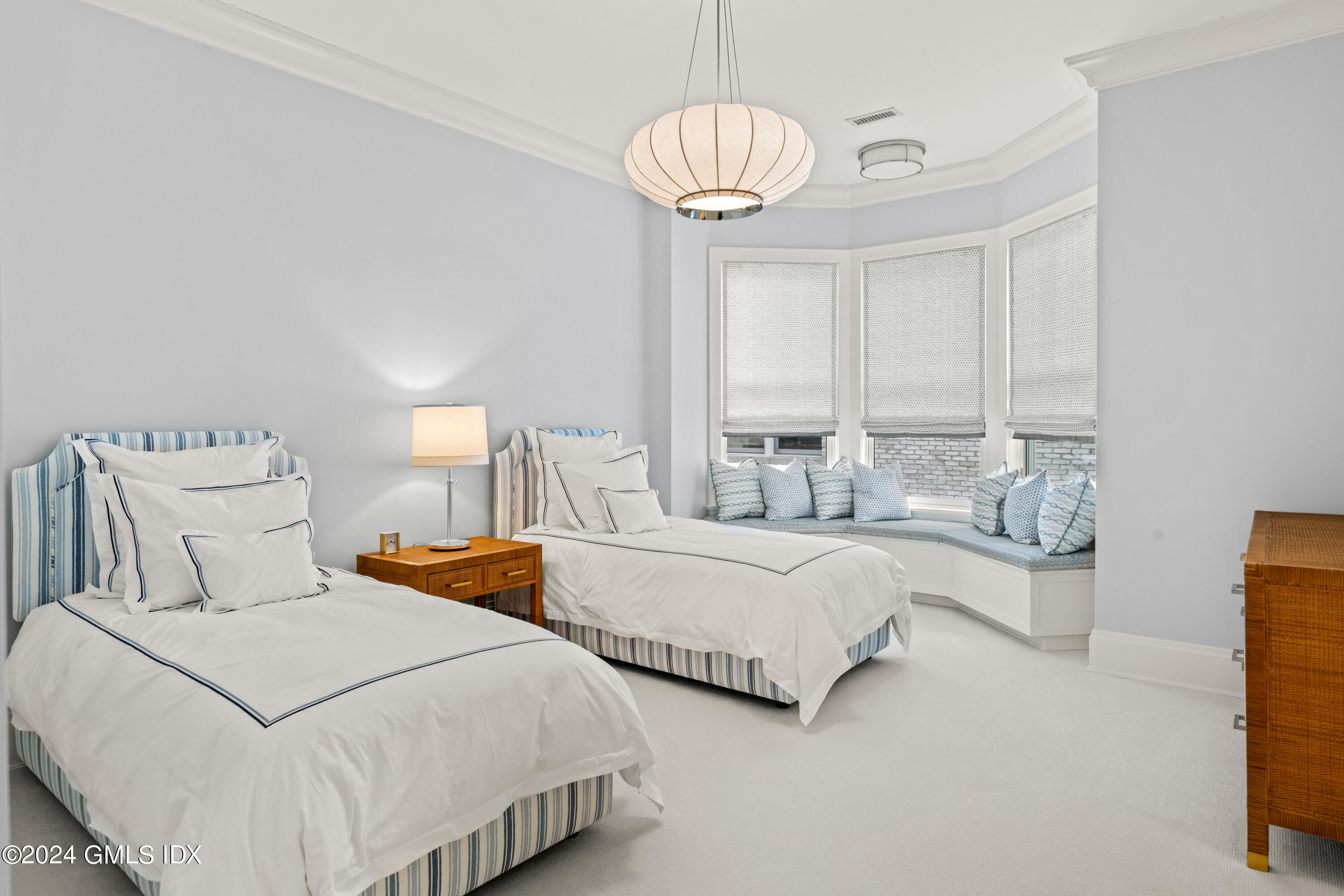 2 Oneida Drive, Unit F Greenwich, CT 06830 - Photo 18 of 31 a bedroom with two beds and painting on the wall