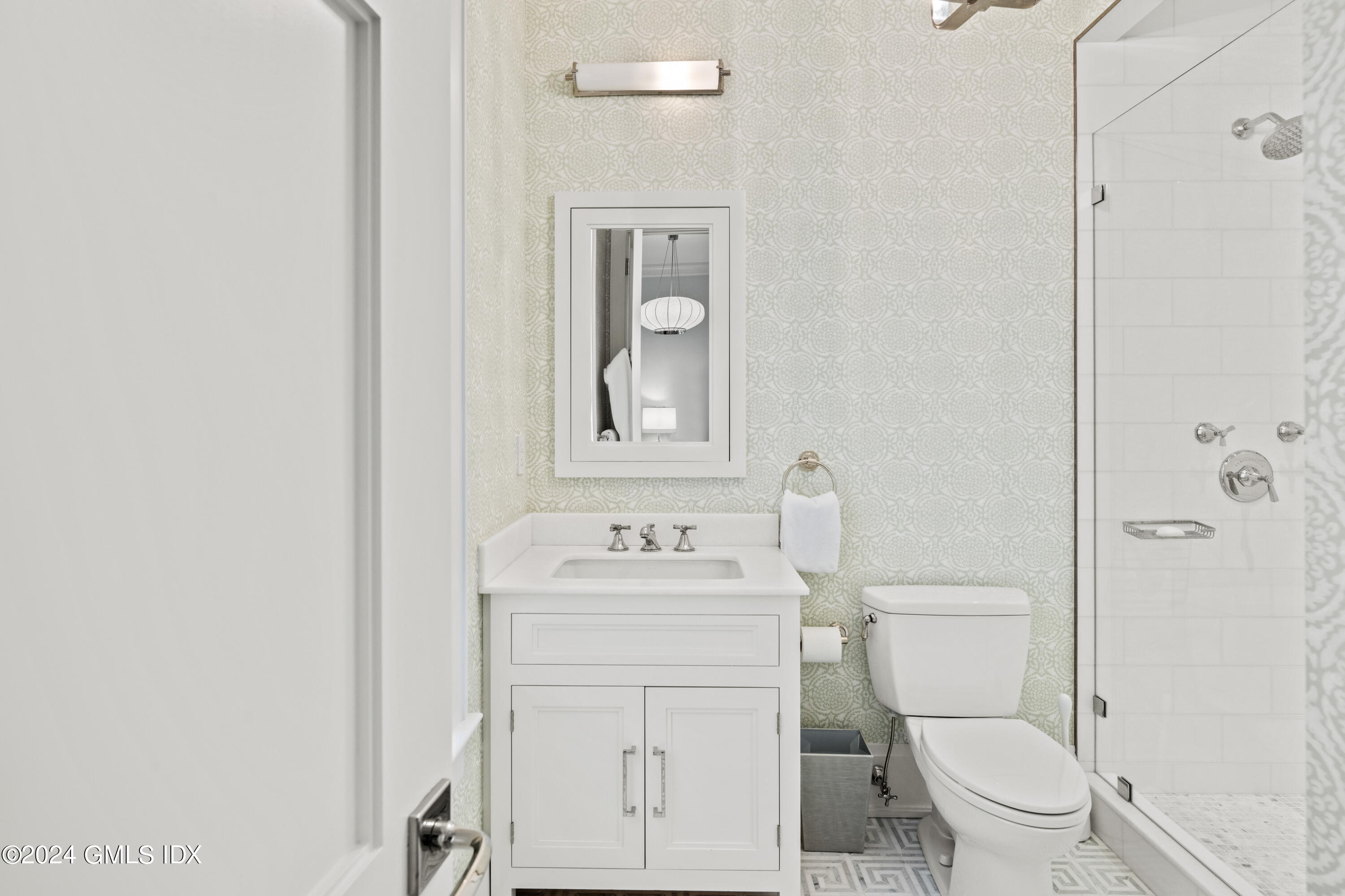 2 Oneida Drive, Unit F Greenwich, CT 06830 - Photo 19 of 31 a bathroom with a toilet sink vanity and mirror