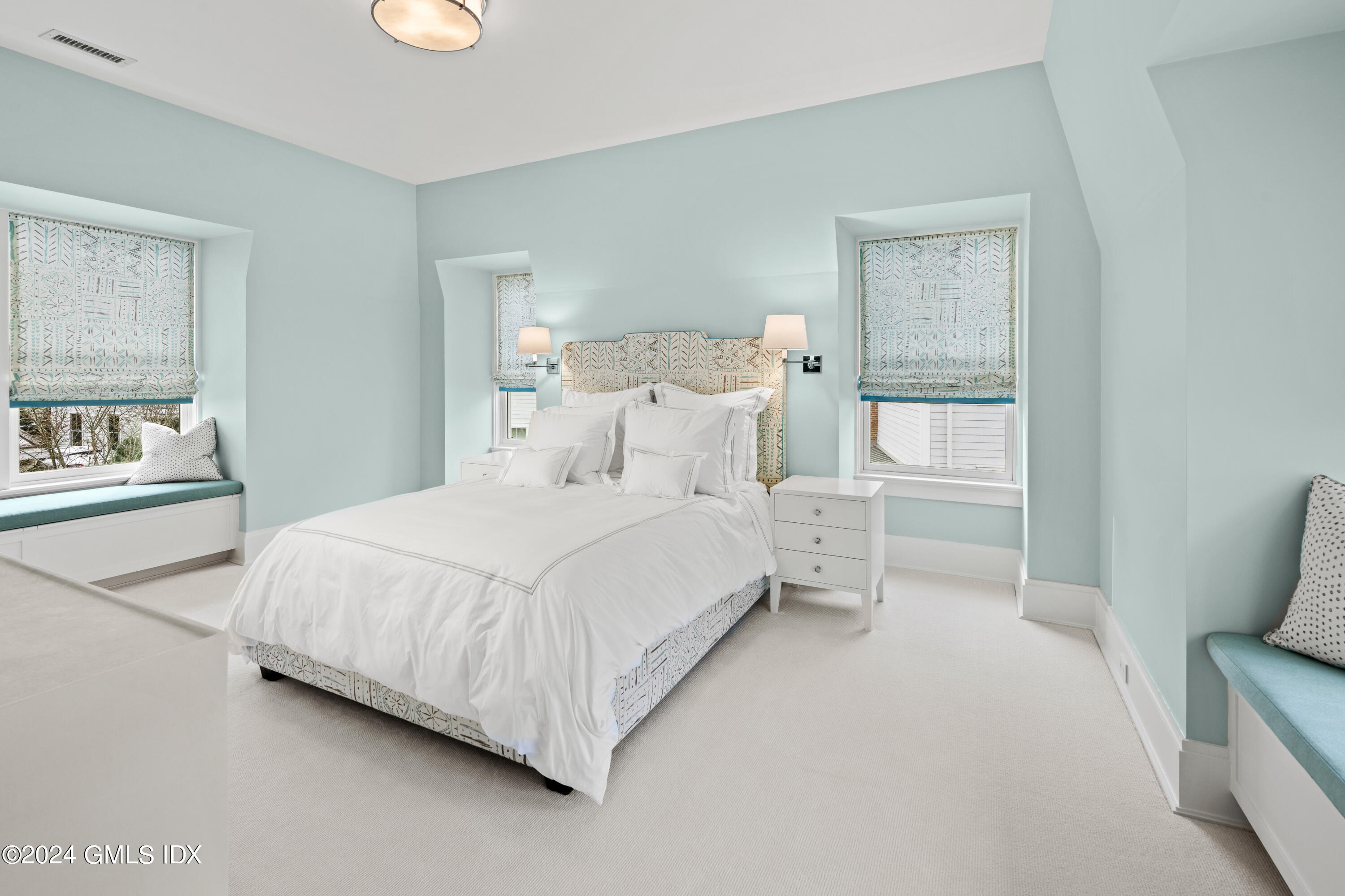 2 Oneida Drive, Unit F Greenwich, CT 06830 - Photo 20 of 31 a bedroom with a bed and a painting