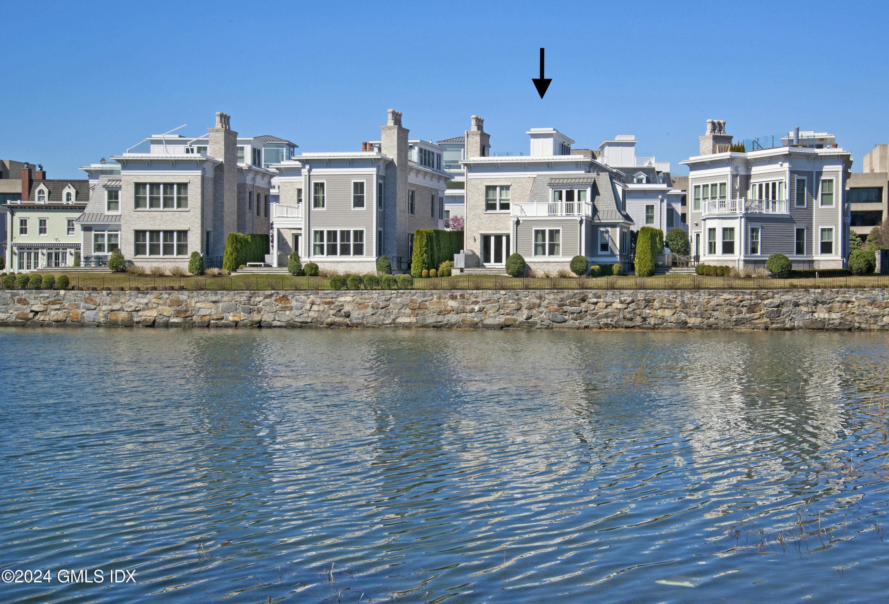 2 Oneida Drive, Unit F Greenwich, CT 06830 - Photo 2 of 31 a view of a lake with building in front of it