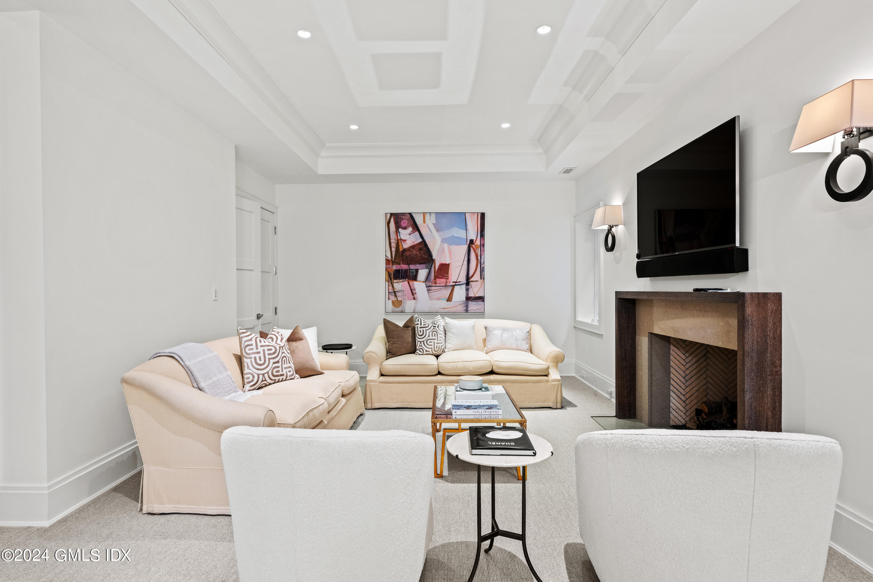 2 Oneida Drive, Unit F Greenwich, CT 06830 - Photo 23 of 31 a living room with furniture a flat screen tv and a fireplace