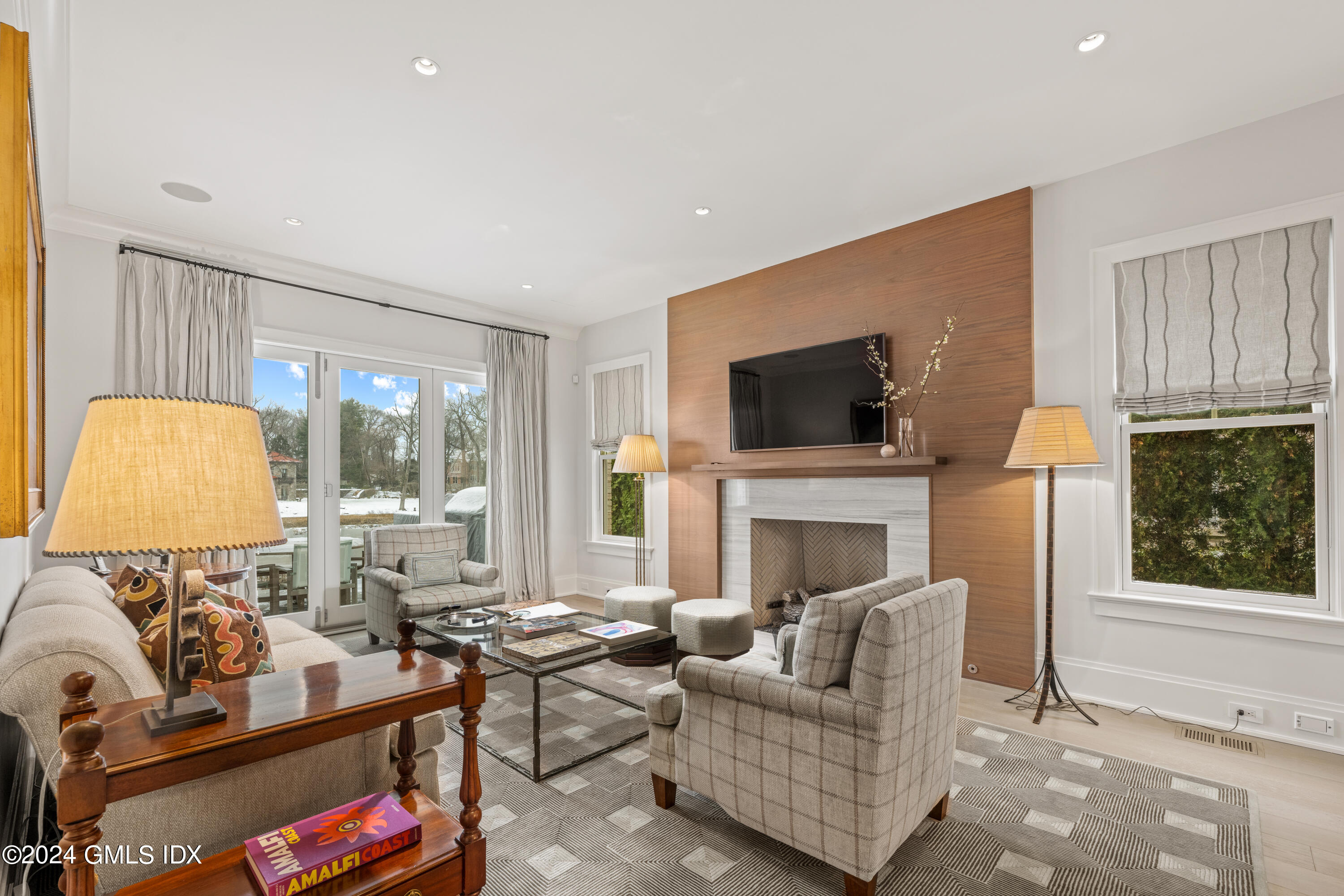 2 Oneida Drive, Unit F Greenwich, CT 06830 - Photo 5 of 31 a living room with furniture a flat screen tv and a fireplace