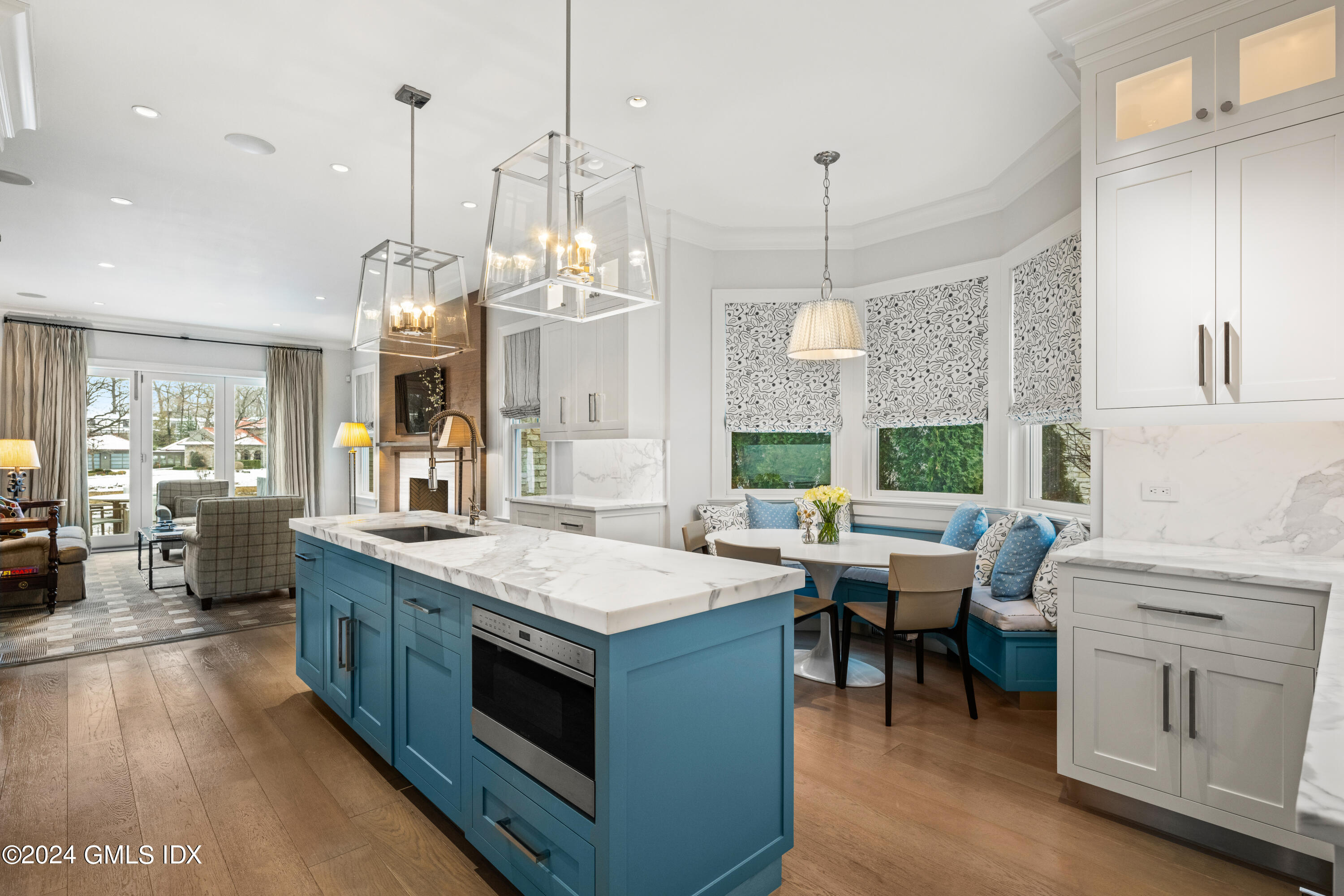 2 Oneida Drive, Unit F Greenwich, CT 06830 - Photo 7 of 31 a large kitchen with kitchen island white cabinets and white appliances