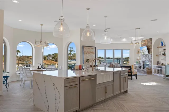 a living room with furniture a chandelier and a large window