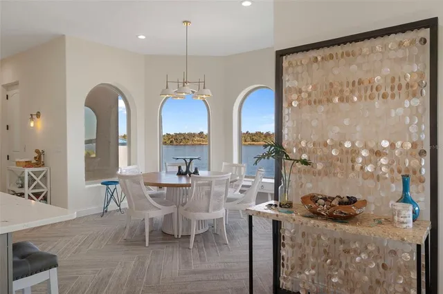 a living room with furniture a fireplace and a large window