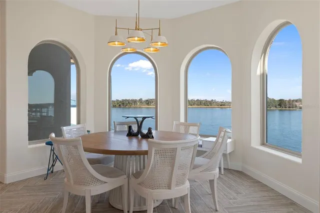a living room with furniture kitchen and a table