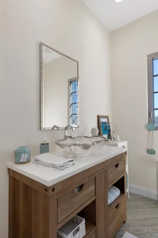a living room with furniture and a painting on the wall