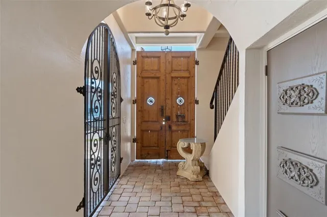 a view of a hallway with a door and stairs