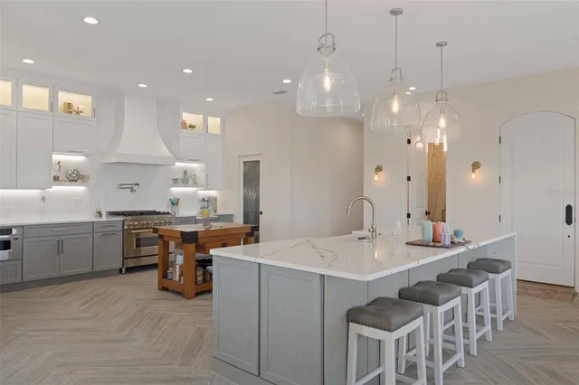 a kitchen with a stove a refrigerator and a sink