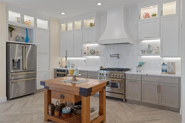 a stove top oven sitting inside of a kitchen