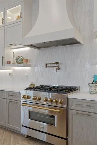 a large kitchen with cabinets a sink a counter space and a view of living room