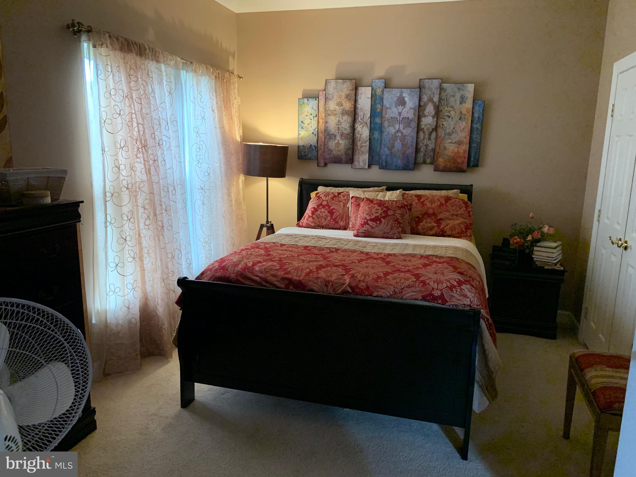 14205 Derby Ridge Road Bowie, MD 20721 - Photo 17 of 53 a bedroom with a bed and wooden floor