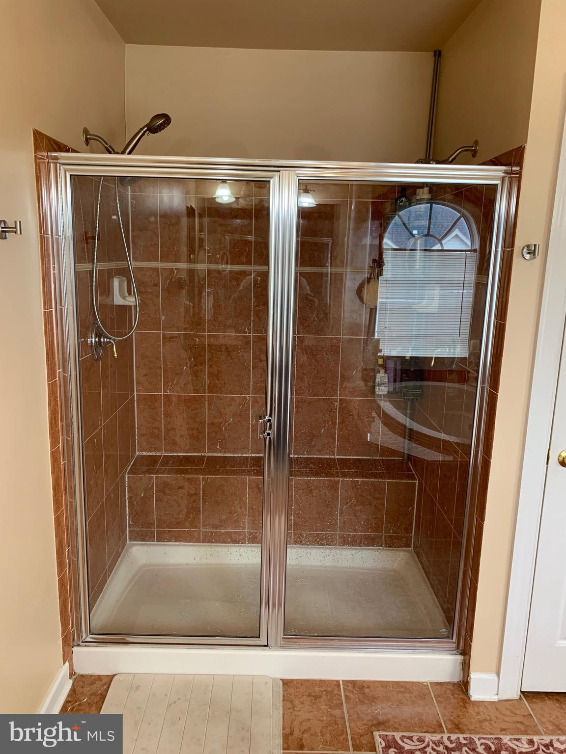 14205 Derby Ridge Road Bowie, MD 20721 - Photo 26 of 53 a bathroom with a glass shower door