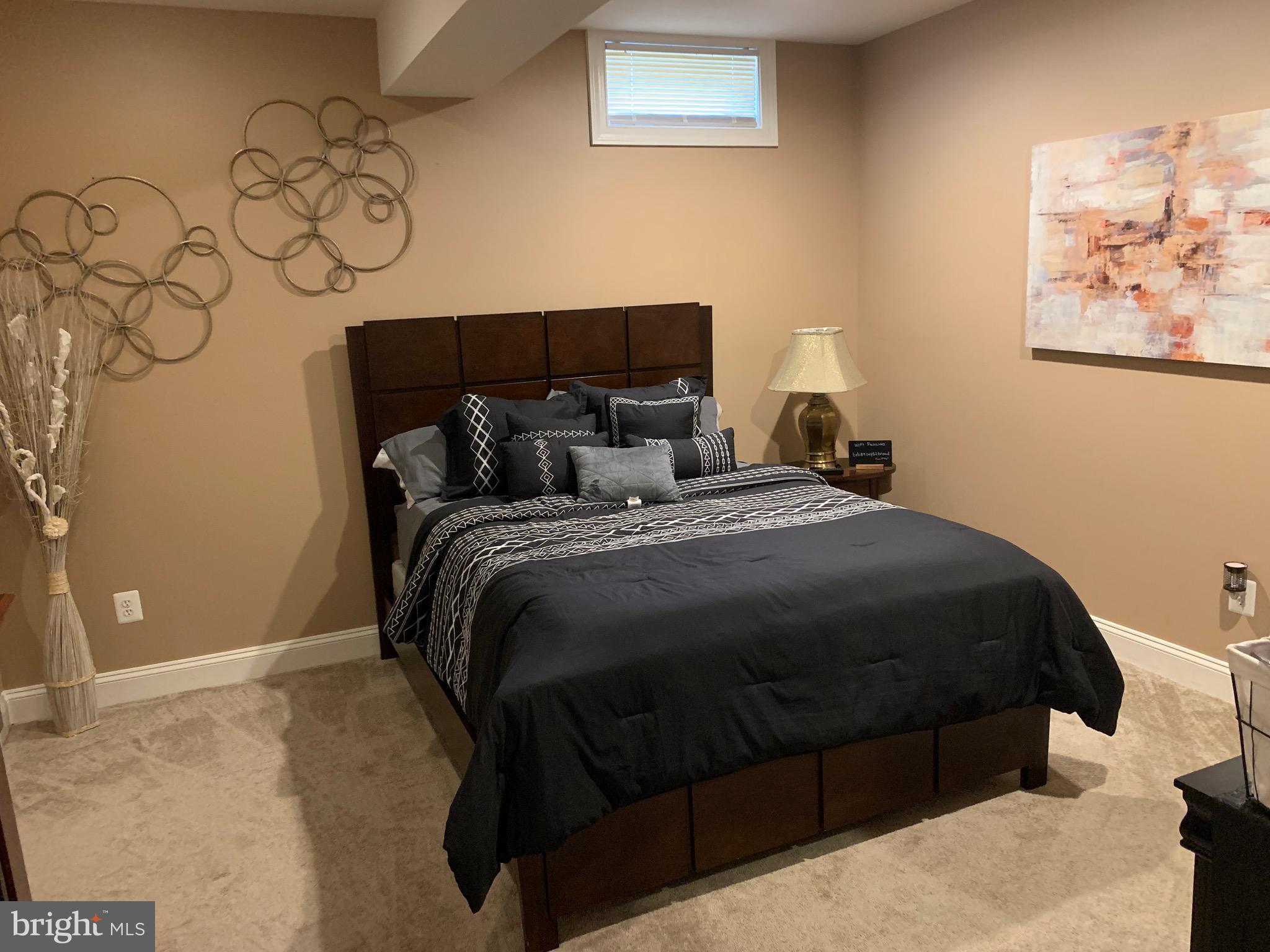 14205 Derby Ridge Road Bowie, MD 20721 - Photo 34 of 53 a bedroom with a bed and wall painting