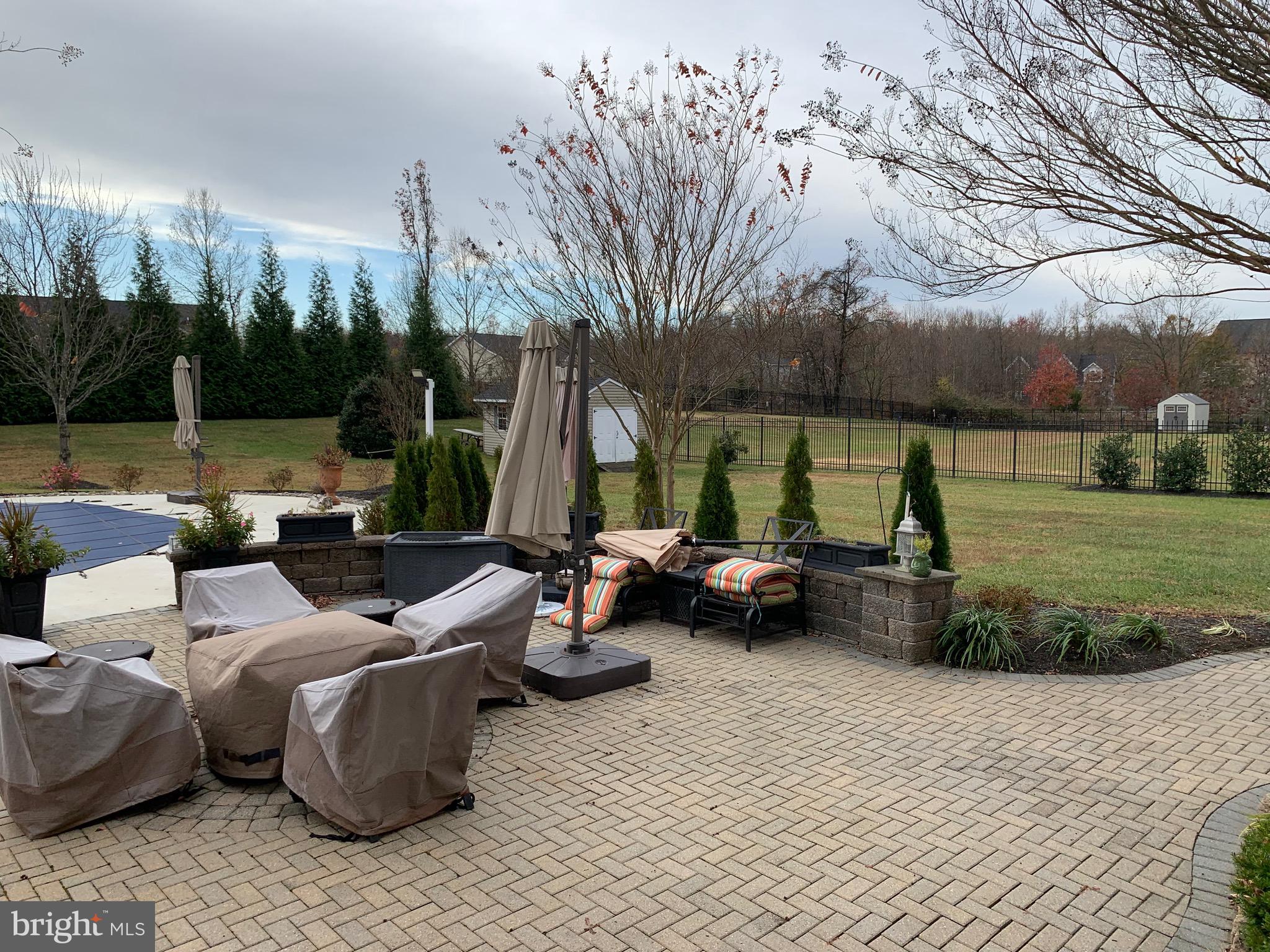 14205 Derby Ridge Road Bowie, MD 20721 - Photo 45 of 53 a view of a patio with couches chairs and a fire pit