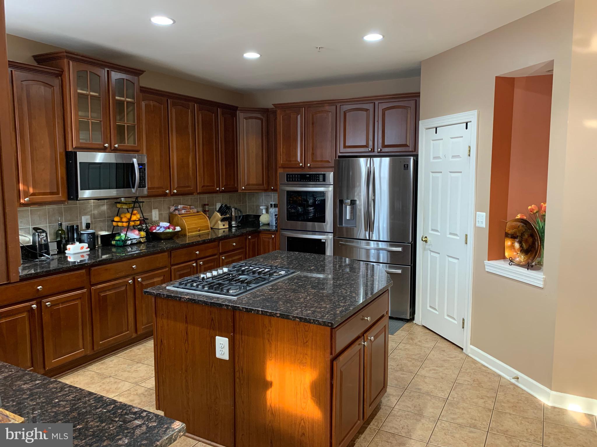 14205 Derby Ridge Road Bowie, MD 20721 - Photo 10 of 53 a kitchen with stainless steel appliances granite countertop a stove refrigerator and a sink